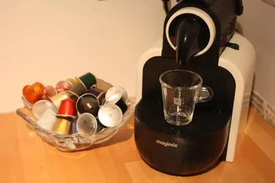 a coffee maker sitting on a table with a glass at Studio Apartment Alba in La Hulpe