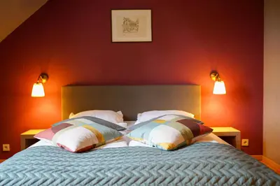 a bedroom with a bed with two pillows on it at Hotel Prins van Oranje in Diest