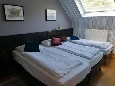 a group of three beds in a room at Hotel Prins van Oranje in Diest