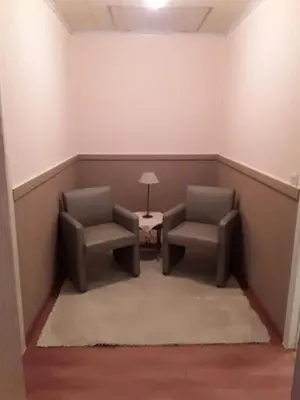 a room with two chairs and a table and a lamp at Wenceslas Cobergher III in Bertem