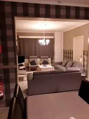 a large living room with couches and a chandelier at Wenceslas Cobergher III in Bertem