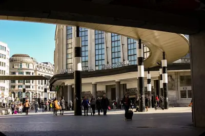 a group of people walking in front of a building at ALMA Grand Place Hotel in Brussels