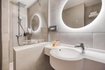 a bathroom with a sink and a shower at ALMA Grand Place Hotel in Brussels
