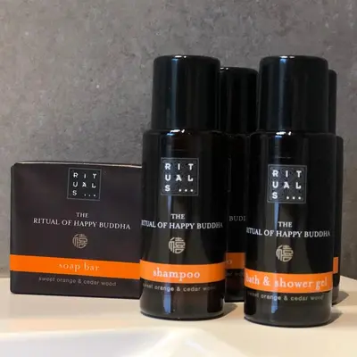 a group of three bottles of hair oil sitting on a shelf at B&B Garden55 in Mechelen