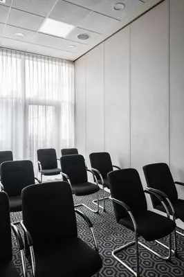 an empty waiting room with chairs in it at pentahotel Leuven in Leuven