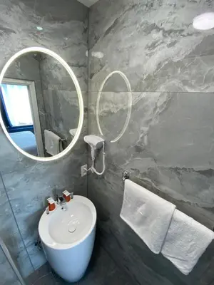 a bathroom with a white sink and a mirror at Hotel Windsor in Brussels