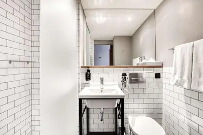 a white bathroom with a sink and a toilet at Pentahotel Brussels Airport in Diegem