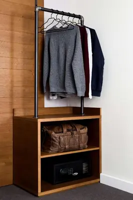 a closet with a wooden wall and a clothes rack at Pentahotel Brussels Airport in Diegem
