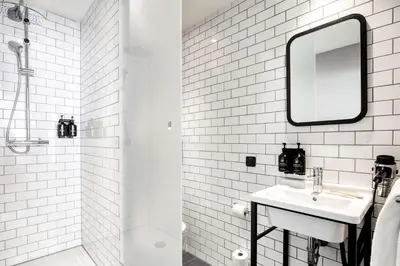 a white bathroom with a sink and a mirror at Pentahotel Brussels Airport in Diegem