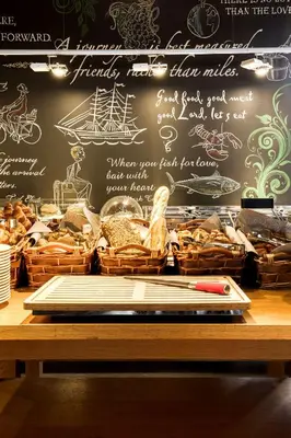 a wall with a chalkboard with baskets of bread at Pentahotel Brussels Airport in Diegem