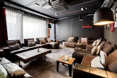 a living room with couches and a table at Pentahotel Brussels Airport in Diegem