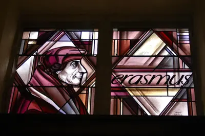 a stained glass window with a depiction of a man at Erasmus Hotel in Ghent