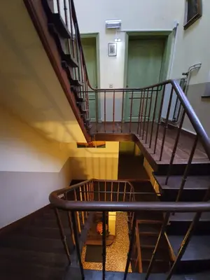 a spiral staircase in a building with a stair case at Erasmus Hotel in Ghent