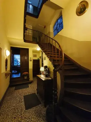 a hallway with a spiral staircase in a house at Erasmus Hotel in Ghent