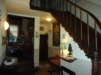a living room with a staircase and a christmas tree at Erasmus Hotel in Ghent