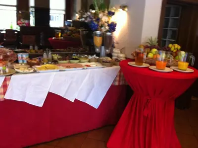 a red and white table with a buffet of food at Hotel Le Centenaire Brussels Expo in Brussels