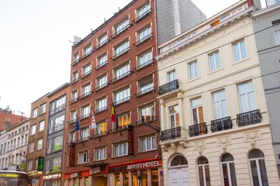 a building on a city street with buildings at Wellness Apart Hotel in Brussels