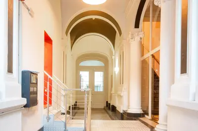 a hallway with a staircase in a building at Wellness Apart Hotel in Brussels