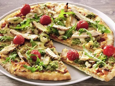 two slices of pizza on a white plate at ibis Aalst in Aalst