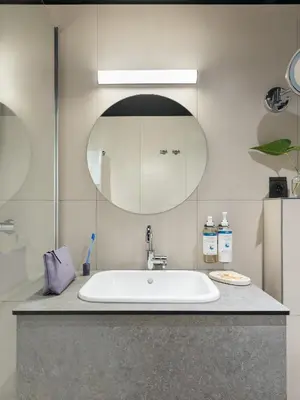 a bathroom with a sink and a mirror at Numa Brussels Royal Galleries in Brussels