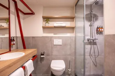 a bathroom with a shower and a toilet and a sink at Hotel Indigo Antwerp City Centre by IHG in Antwerp