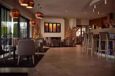 a restaurant with chairs and tables in a lobby at Van der Valk Hotel Dennenhof in Brasschaat