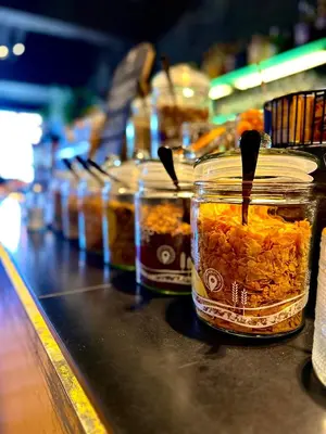 a row of jars of food on a counter at Hotel Vé in Mechelen