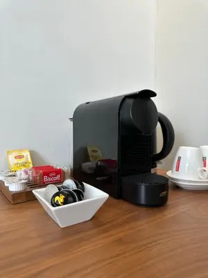 a coffee maker sitting on top of a wooden table at Hotel Vé in Mechelen