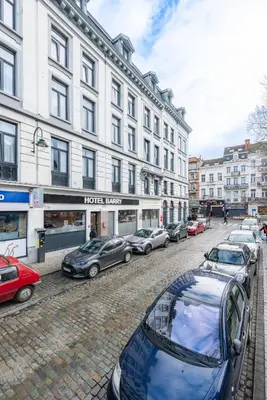 a row of cars parked in front of a building at Hotel Barry in Brussels