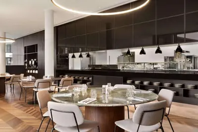 a restaurant with tables and chairs and a bar at Hotel Dolce La Hulpe Brussels in La Hulpe