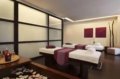 a hotel room with two beds and a table at Hotel Dolce La Hulpe Brussels in La Hulpe