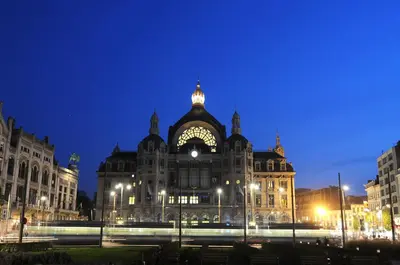 a large building with lights in front of it at night at Arass Hôtel & Business Flats in Antwerp