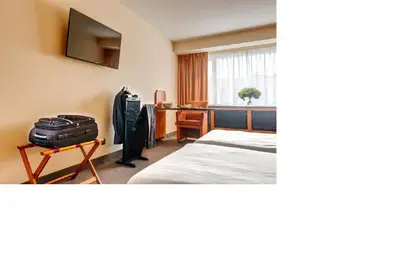 a hotel room with a bed and a desk at Arass Hôtel & Business Flats in Antwerp