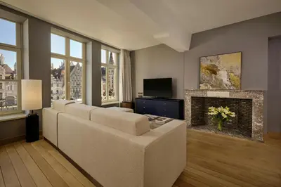 a living room with a couch and a fireplace at Ghent Marriott Hotel in Ghent
