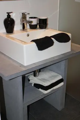 a bathroom counter with a sink with towels on it at Het Schalks Genot in Poppel
