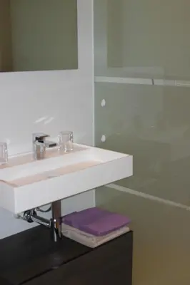 a bathroom with a white sink and a mirror at Het Schalks Genot in Poppel