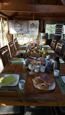 a wooden table with plates of food on it at Het Schalks Genot in Poppel