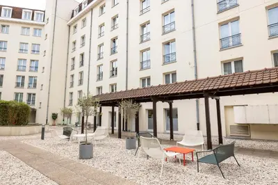 a group of chairs and tables in front of a building at Citadines Sainte-Catherine Brussels in Brussels