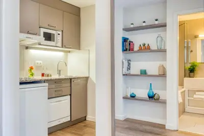 a kitchen with a sink and a microwave at Citadines Toison d'Or Brussels in Brussels