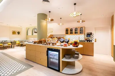 a kitchen with a counter with food on it at Citadines Toison d'Or Brussels in Brussels