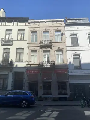 a blue car parked in front of a building at Hooome in Brussels