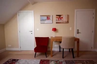 a dining room with a table and two chairs at Hooome in Brussels