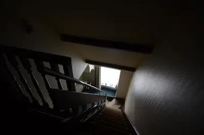 a stairway with a window in a building at Hotel Malcot in Mechelen
