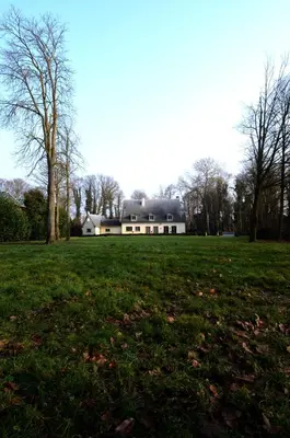 a large house in the middle of a field at Hotel Malcot in Mechelen