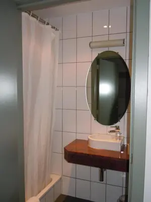 a bathroom with a sink and a mirror at Hotel Malcot in Mechelen