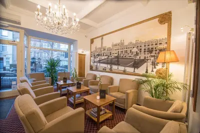 a waiting room with chairs and a painting on the wall at Hotel The Lord in Ghent