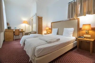 a hotel room with a large bed with white sheets at Hotel The Lord in Ghent
