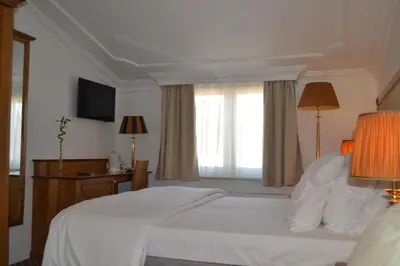 a hotel room with a bed and a television at Hotel The Lord in Ghent