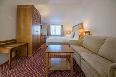 a hotel room with a couch and a bed at Hotel The Lord in Ghent