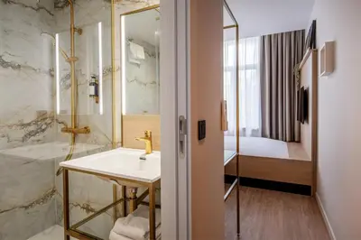 a bathroom with a sink and a shower at Jill Hotel Brussels in Brussels